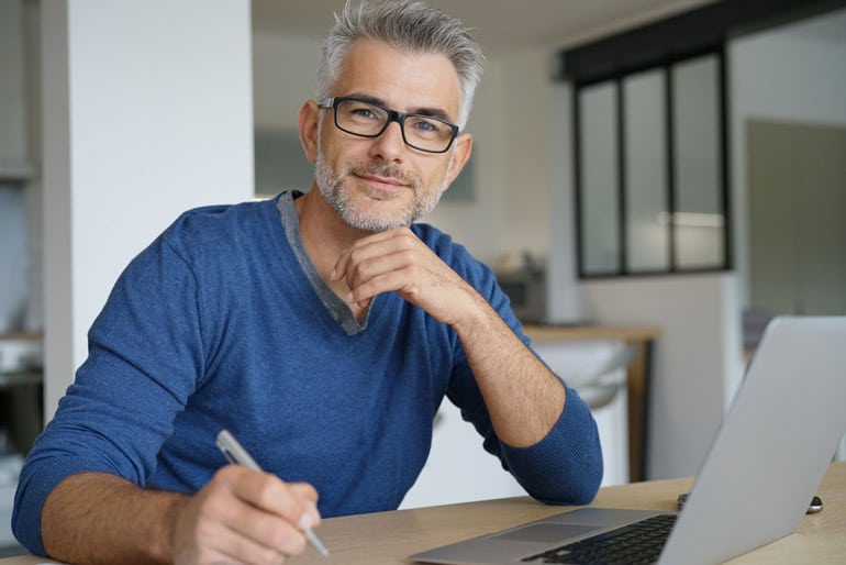 Business man taking notes on risk management