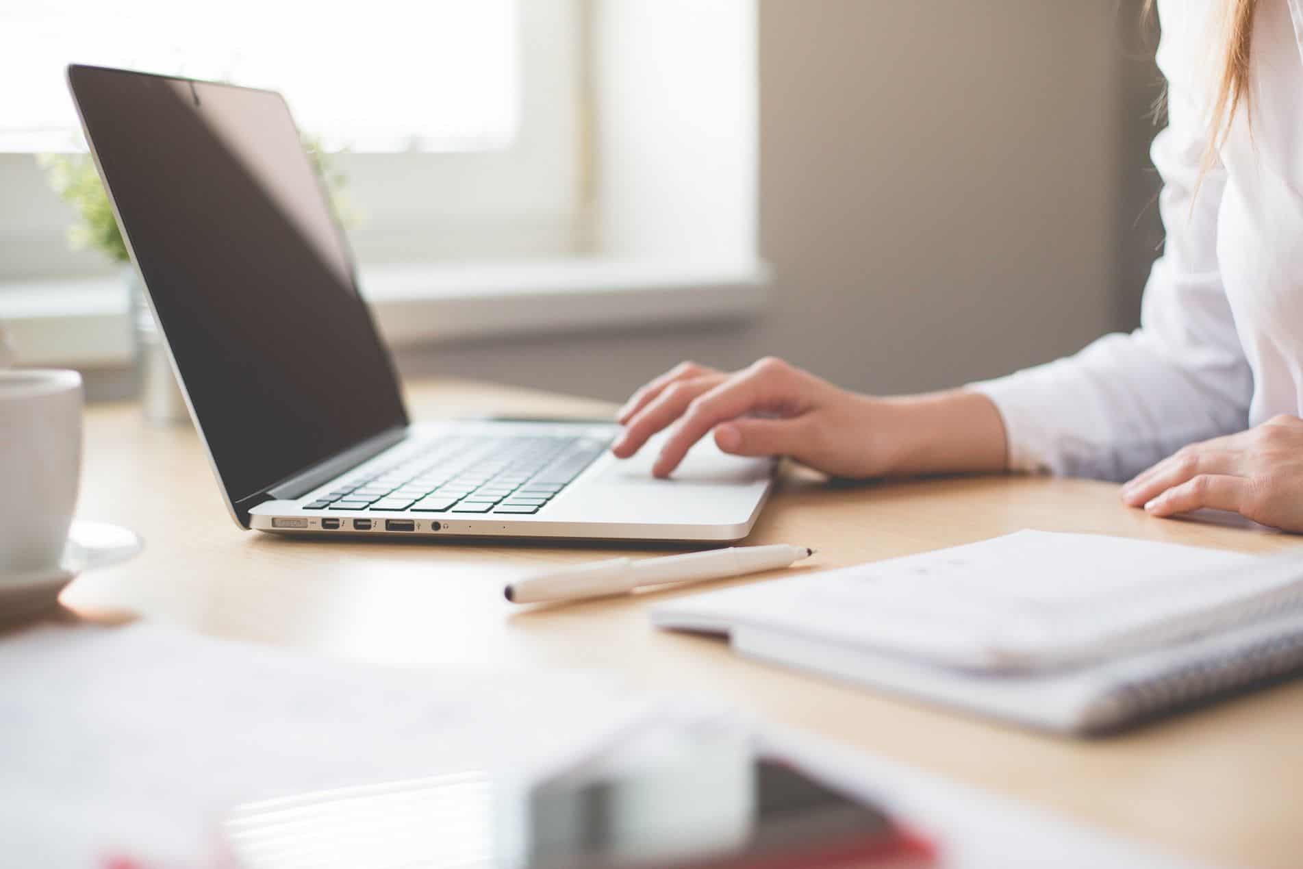 Close up of business woman at her desk working on PMP qualifications