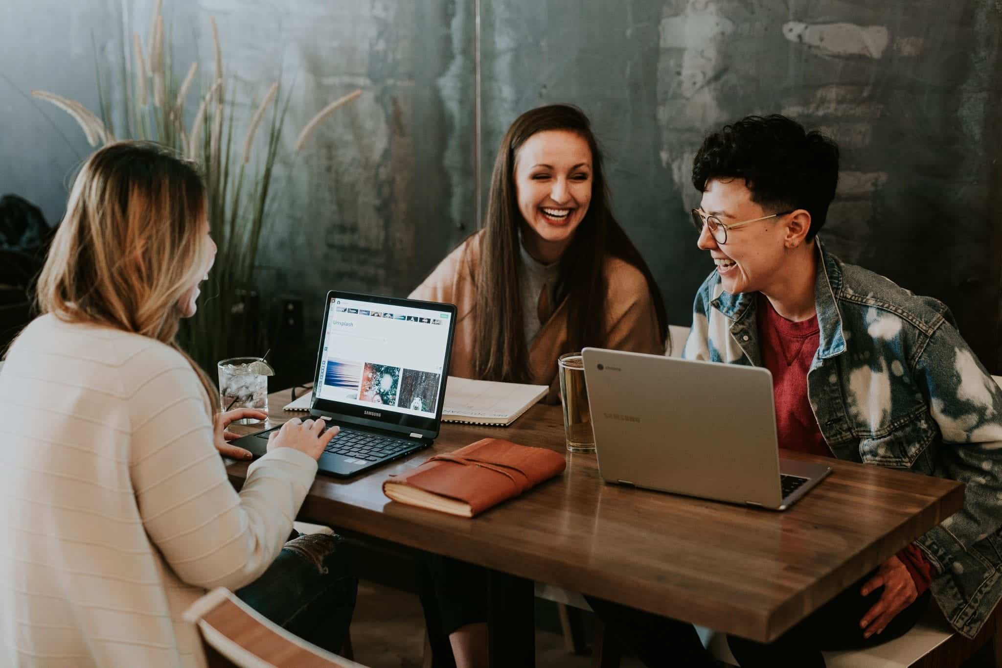 Group of colleagues at a conference table discussing getting their CAPM certification
