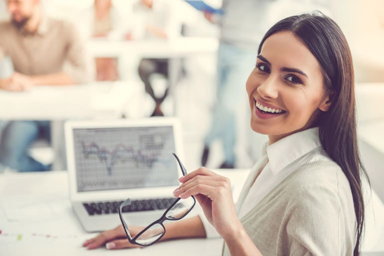 Young woman smiling over shoulder using emotional intelligence