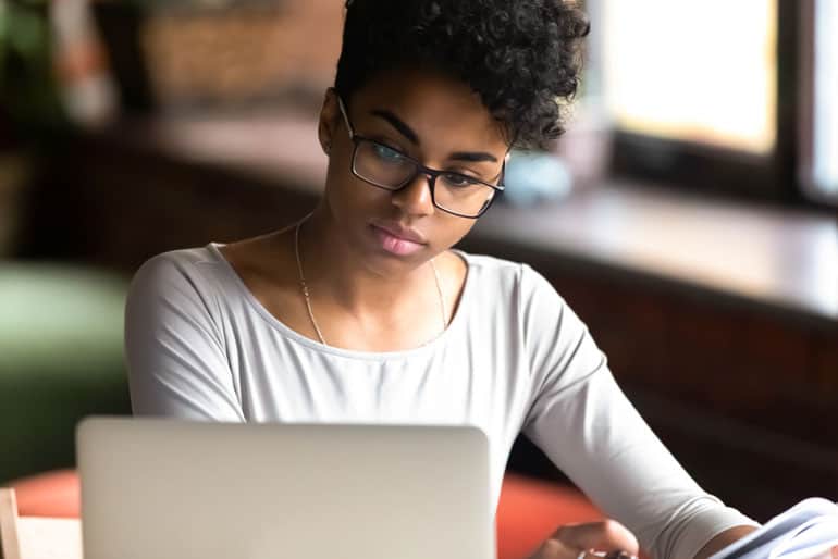 African American woman using computer for PMP exam online training