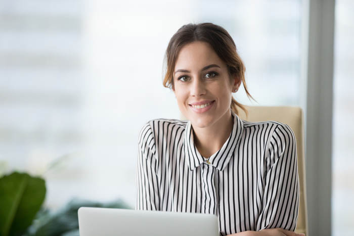 Woman at her computer reading about agile tools to pass the PMP Exam