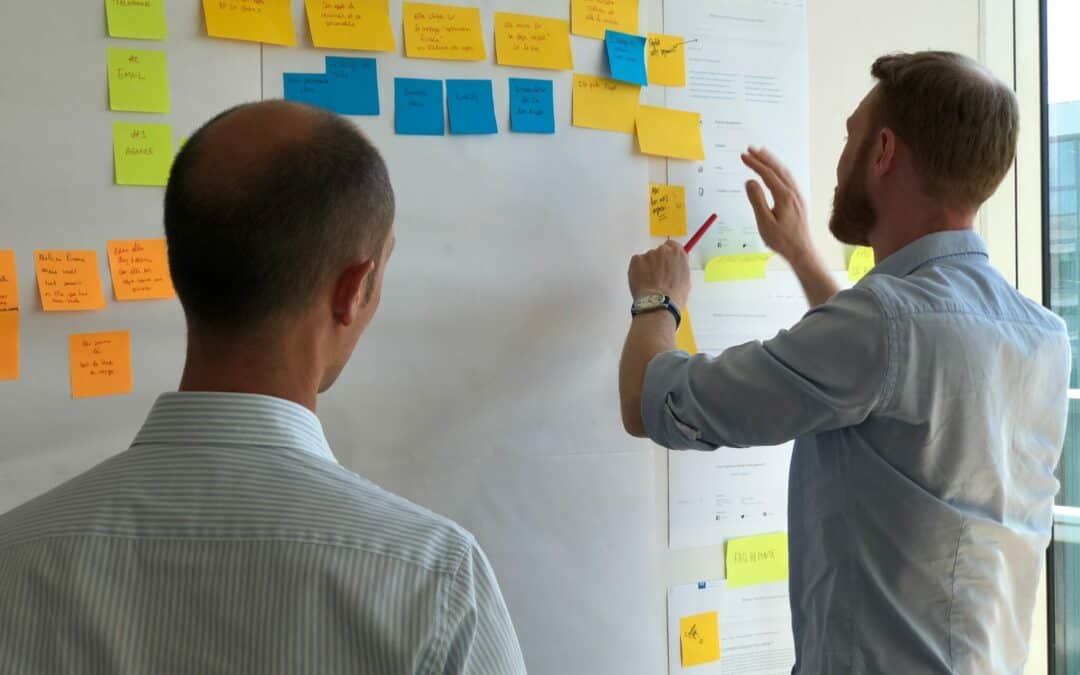 Two developers using post it notes to update projectwork