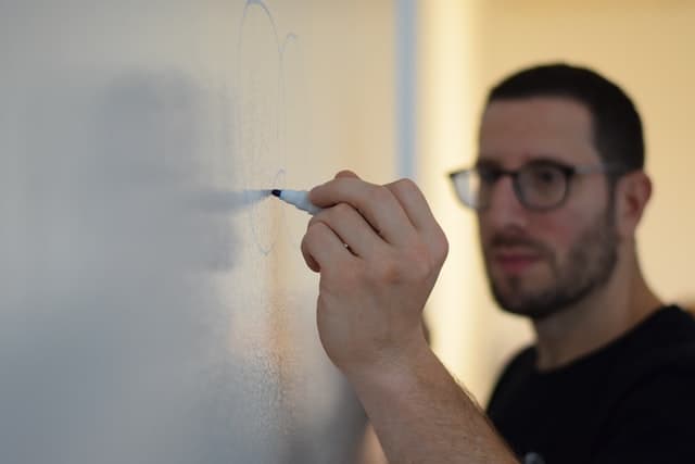 Man working on agile risk at white board