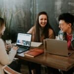 Group of colleagues at a conference table discussing getting their CAPM certification