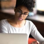 African American woman using computer for PMP exam online training