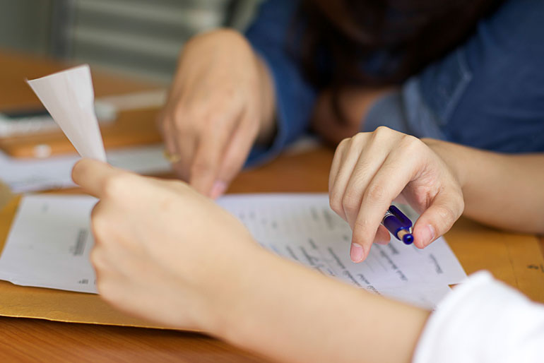 Close up of two colleagues reviewing risk analysis on projects