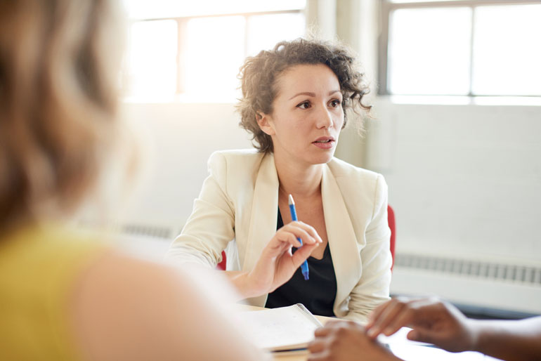 Woman discussing resource planning and management in a meeting