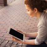 Young woman reading an RMC title on iPad