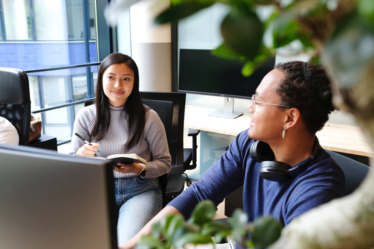 Young female business analyst taking note on an agile project